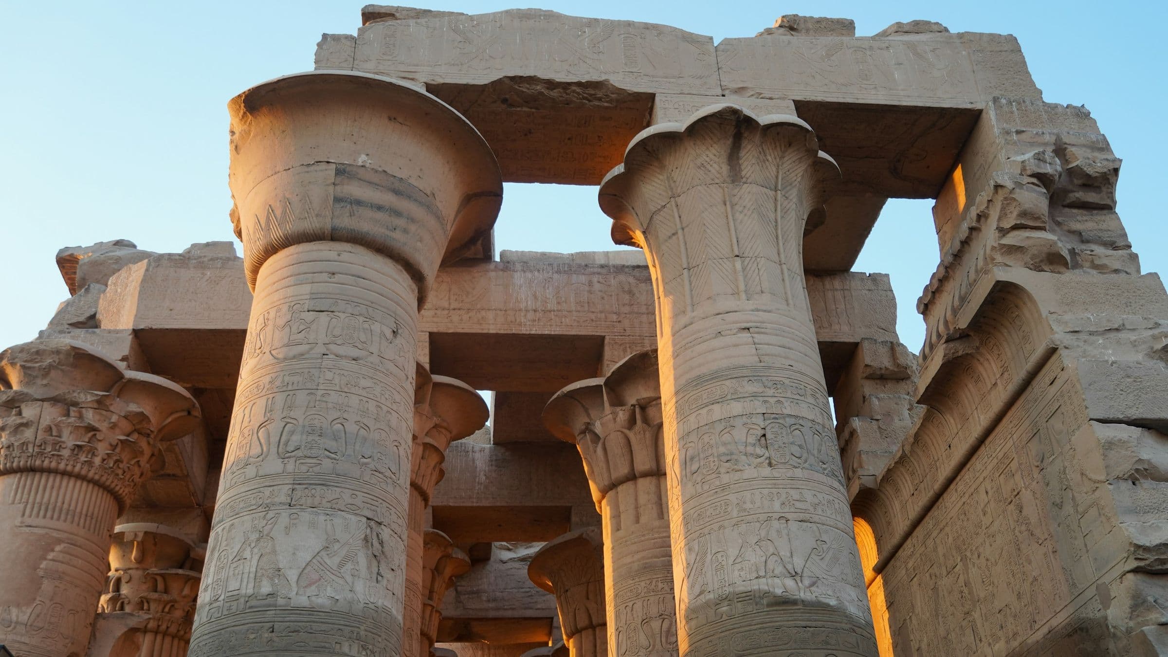 Carved columns of Kom Ombo Temple glowing in late sun