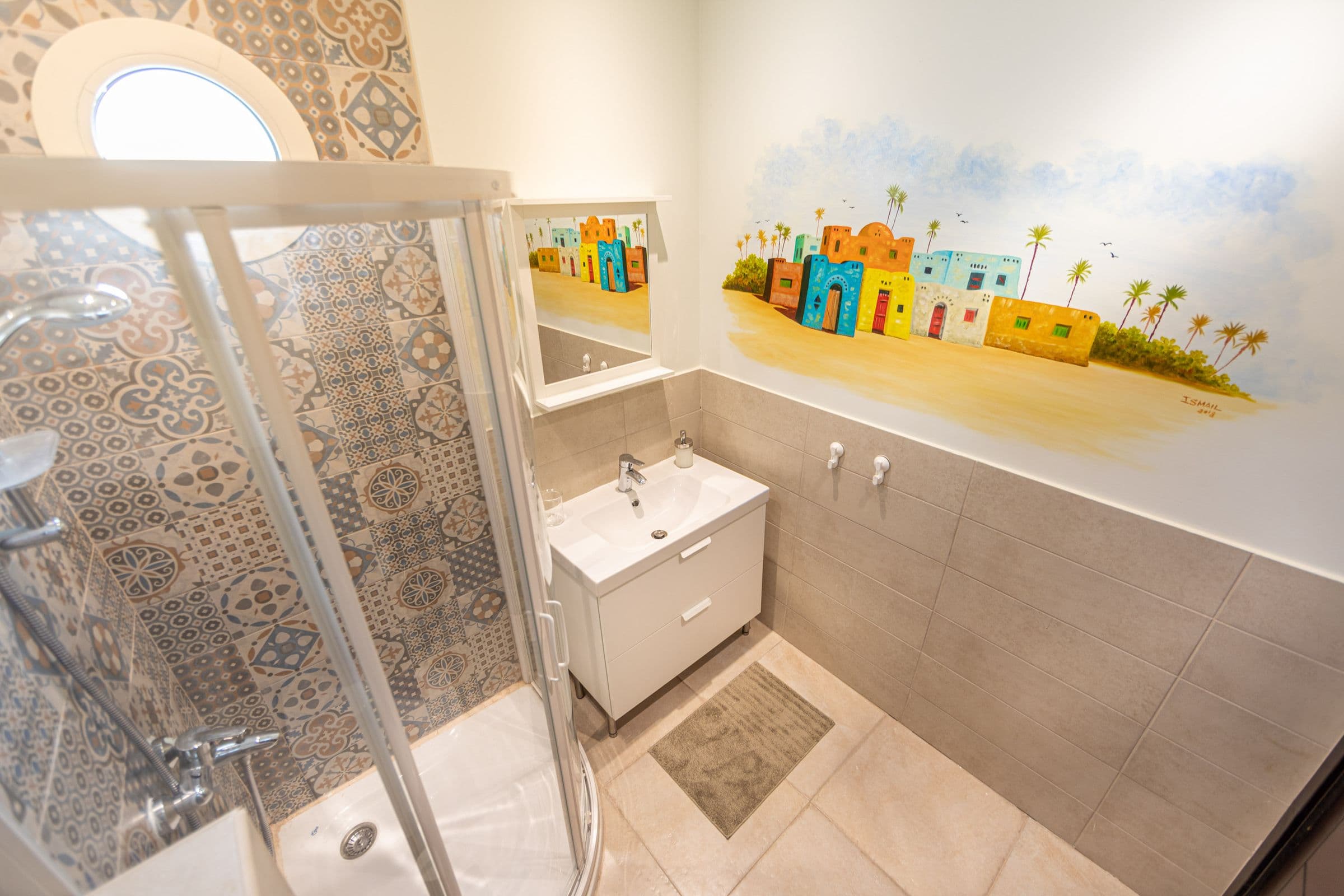 A bathroom with Nubian village artwork aboard Anakob