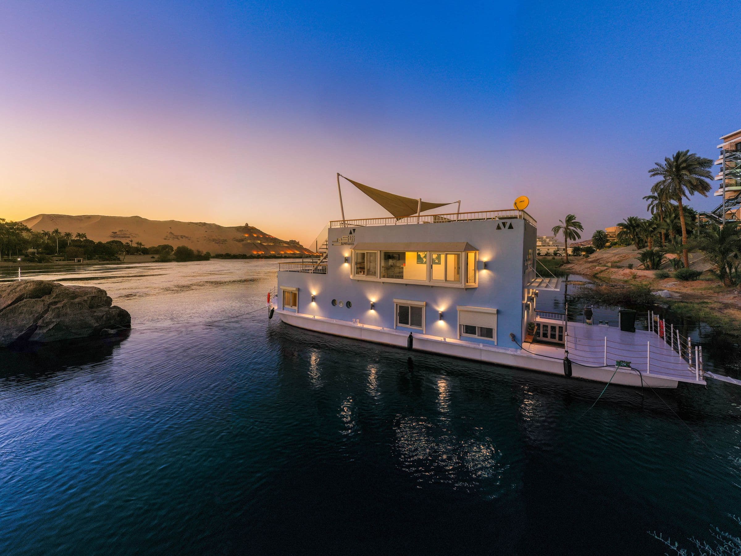 Anakob moored on the Nile at dusk with the west bank behind